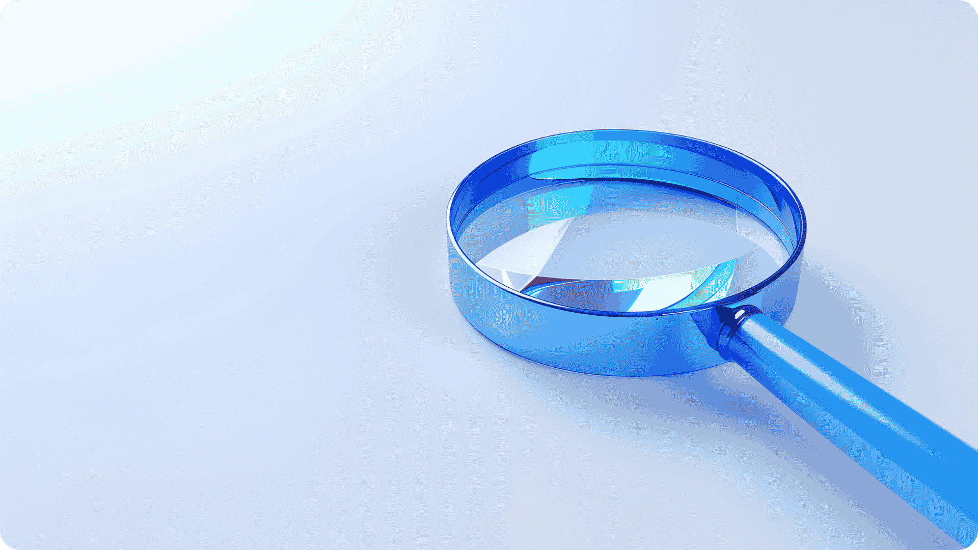A light blue magnifying glass on a plain background